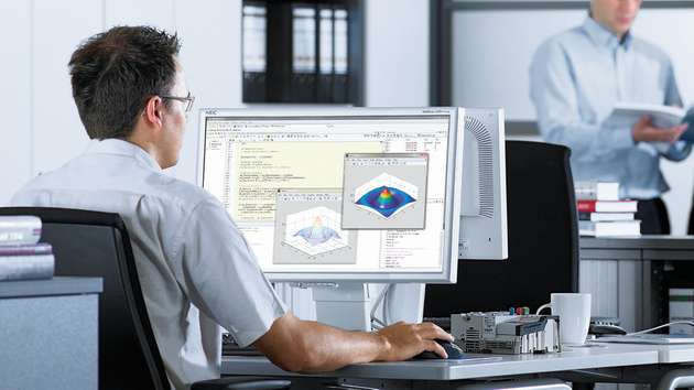 Ingenieur beim Entwickeln einer Steuerung mit modell-basiertem Design und virtueller Inbetriebnahme mit Matlab, Simulink und Rexroth-Steuerung.