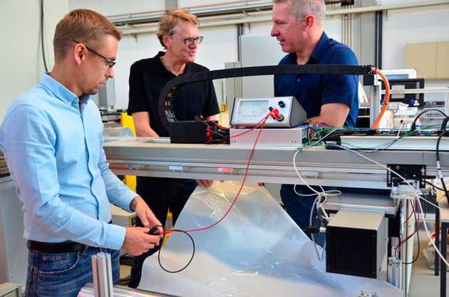 Sascha Wagner (links) und Jürgen Gröninger (rechts) vom Laserzentrum der FH Münster besprechen mit Siegfried Hartmann von EMPAC, wie sich die Folie in die Pilotanlage integrieren lässt.