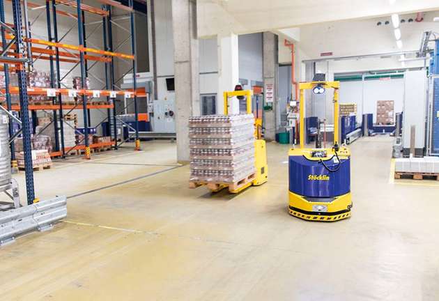 Fahrerlose Transportfahrzeuge des Typs Eagle-Ant 1 fördern Emmi-Produkte zwischen den Anlagen hin und her.