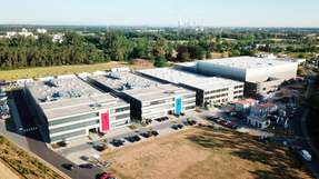Die BMZ-Konzernzentrale in Karlstein am Main, wo derzeit eine dritte Produktionshalle sowie das Logistikcenter entstehen (erstes und zweites Gebäude von rechts). In „Unit 3“ werden künftig die Batteriesysteme für das Joint Venture produziert.