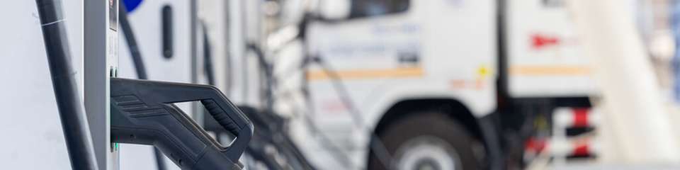 Bei der Depotladung mehrerer E-Lkw steuert ein Energiemanagementsystem die DC-Ladevorgänge fahrzeugscharf und bindet den Netzanschluss, den Batteriespeicher und die Photovoltaikanlage in einen Ladeplan ein.