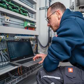 Ein Servicetechniker von Klima Kälte Kopp bei der Inbetriebnahme eines modernen Kühlanlagen-Systems: Über eine Software-Schnittstelle werden alle Funktionen der Anlage überwacht, parametriert und auf maximale Effizienz abgestimmt.
